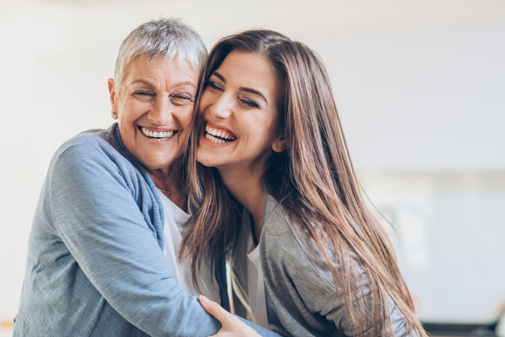 Senior and young women embracing at home