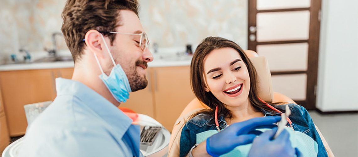 A friendly dentist consulting a patient in a modern dental office, showcasing professional care and expertise in Puyallup.