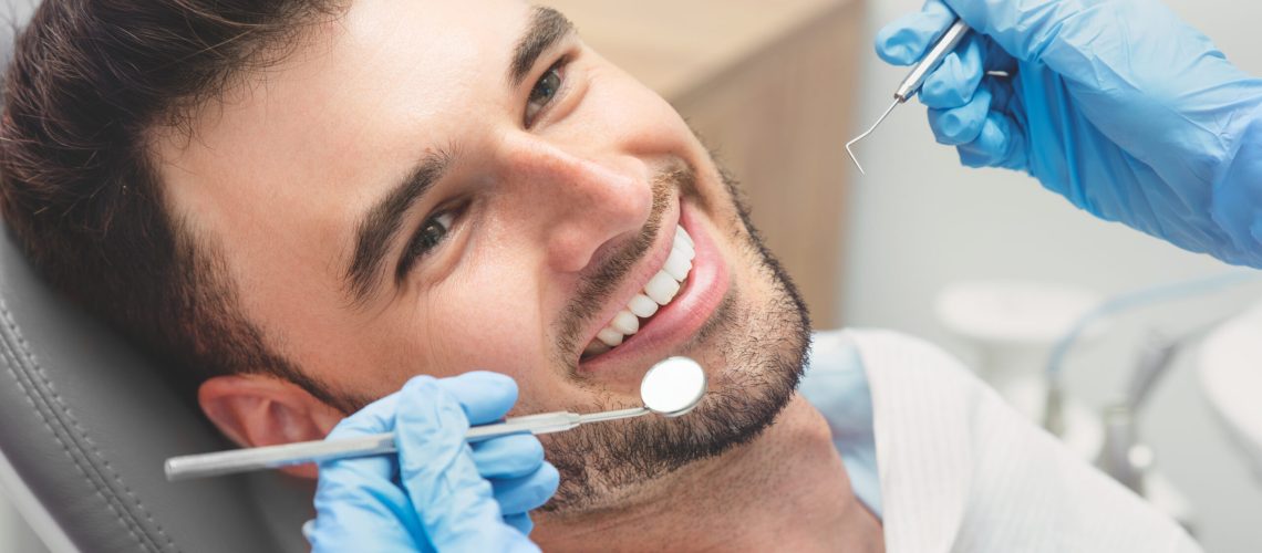 Man having teeth examined at dentists